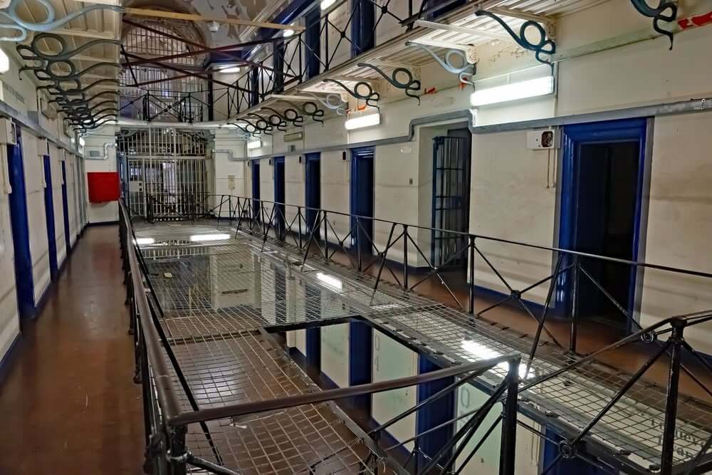 Landing of a Cornish prison wing with cell doors and railings