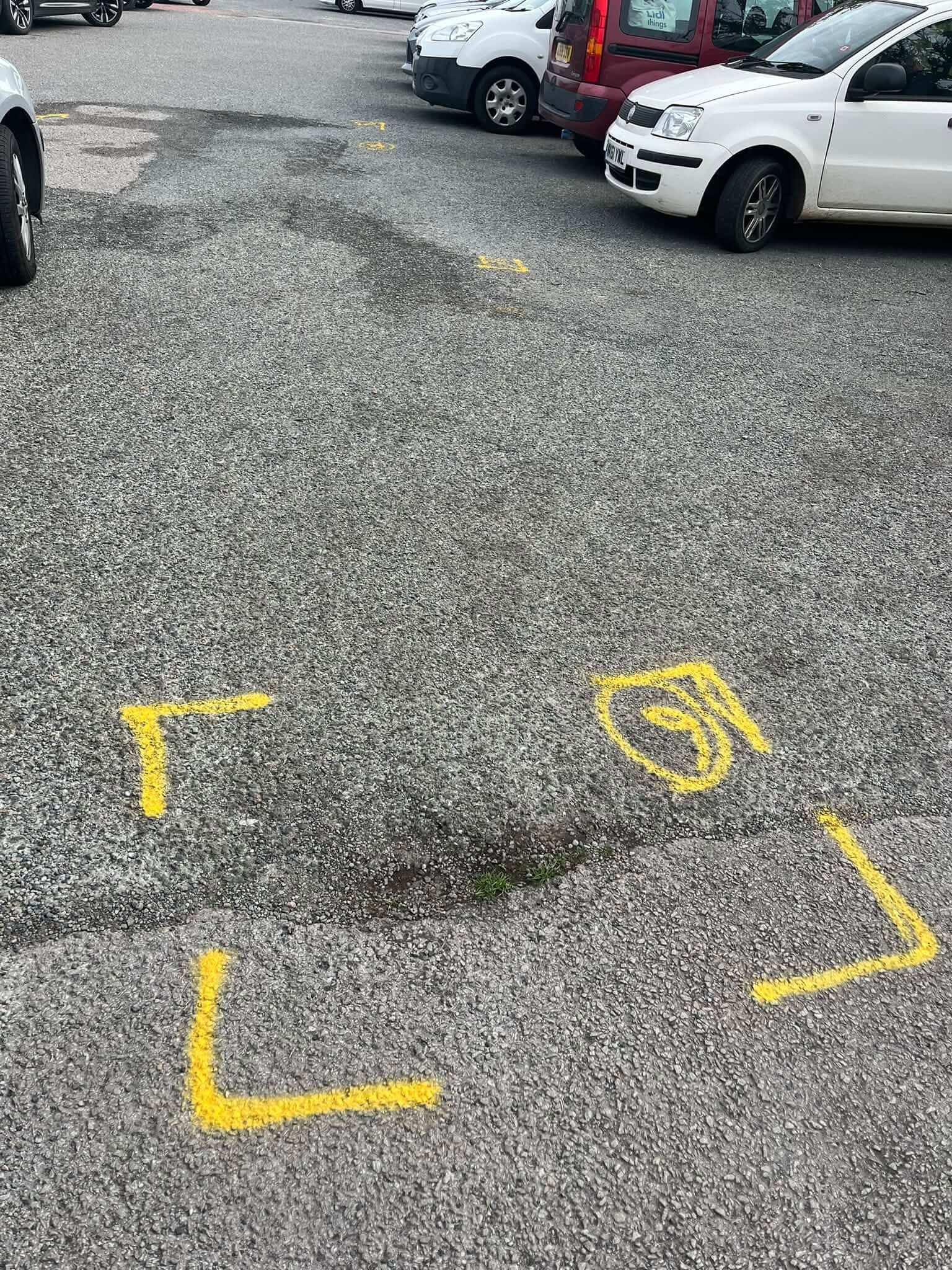 Yellow paint markings on the tarmac at Millbrook car park ahead of resurfacing