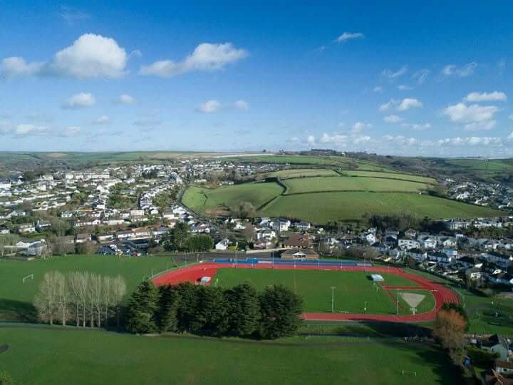 Aerial view of Par Track's athletics track and the village of Par