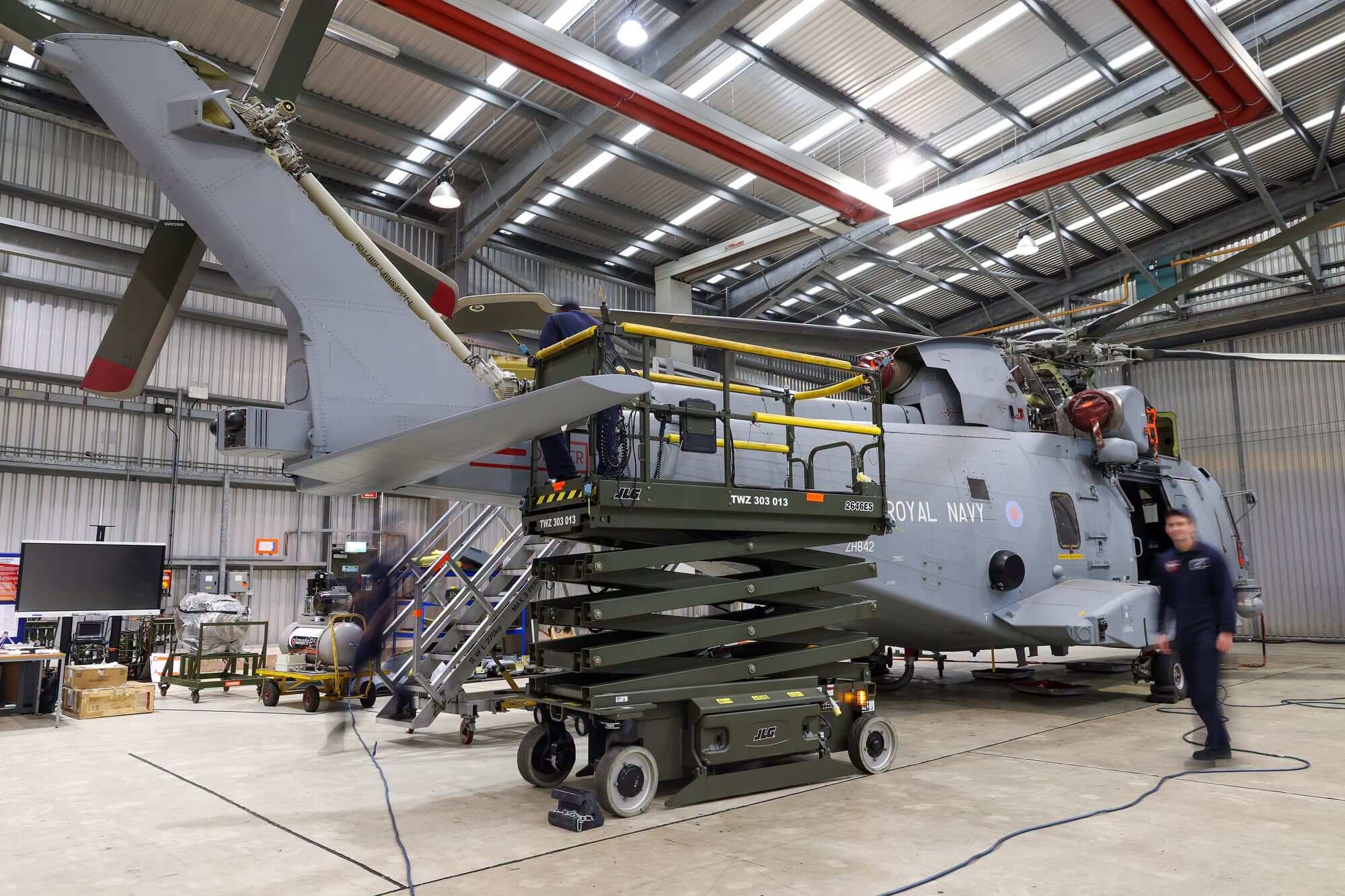 Royal Navy Merlin helicopter undergoing maintenance in a Culdrose hangar