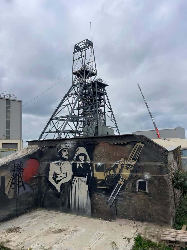 South Crofty headframe behind a mining mural