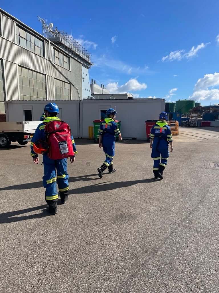 Coastguard rescue officers walking through Falmouth Docks