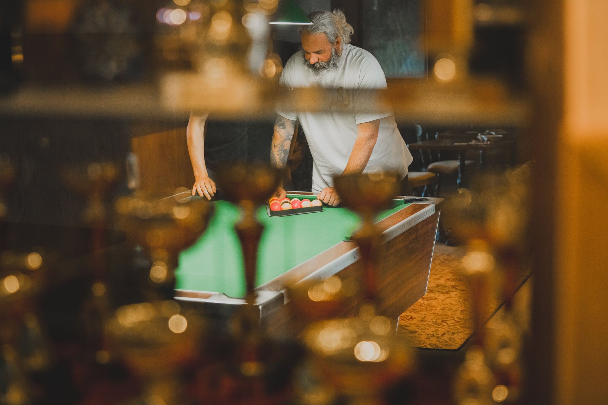 People racking up balls on a pool table in a Falmouth pub