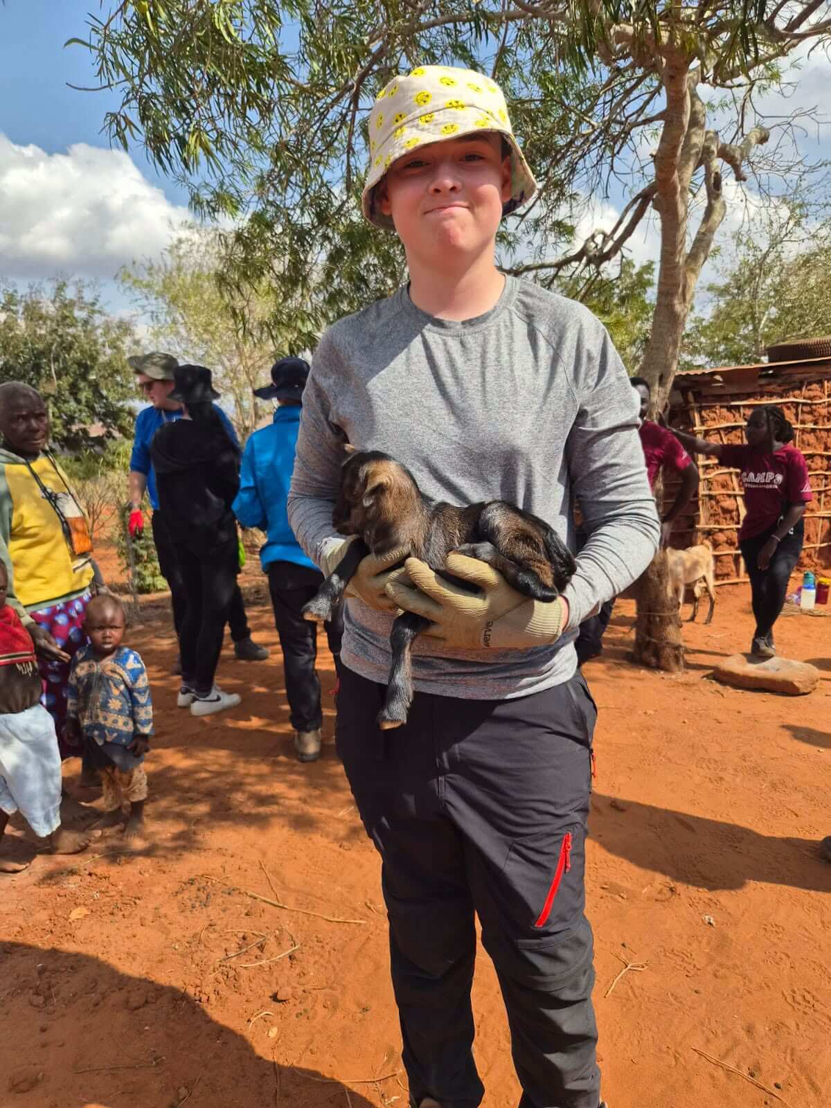 A Pool student helps care for the local livestock in Kenya