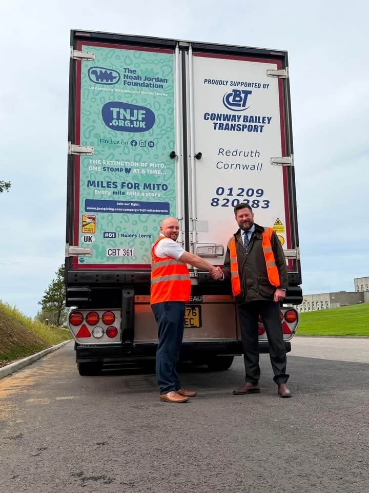 Ben Jordan and Lee Wills shaking hands in front of Noah's Lorry