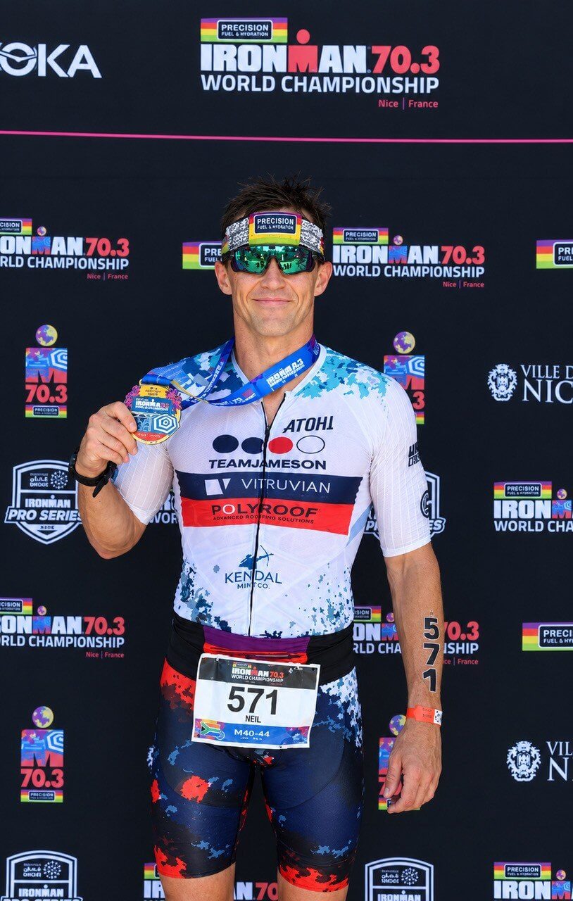 Neil Eddy holding his medal at the IRONMAN 70.3 World Championship in Nice