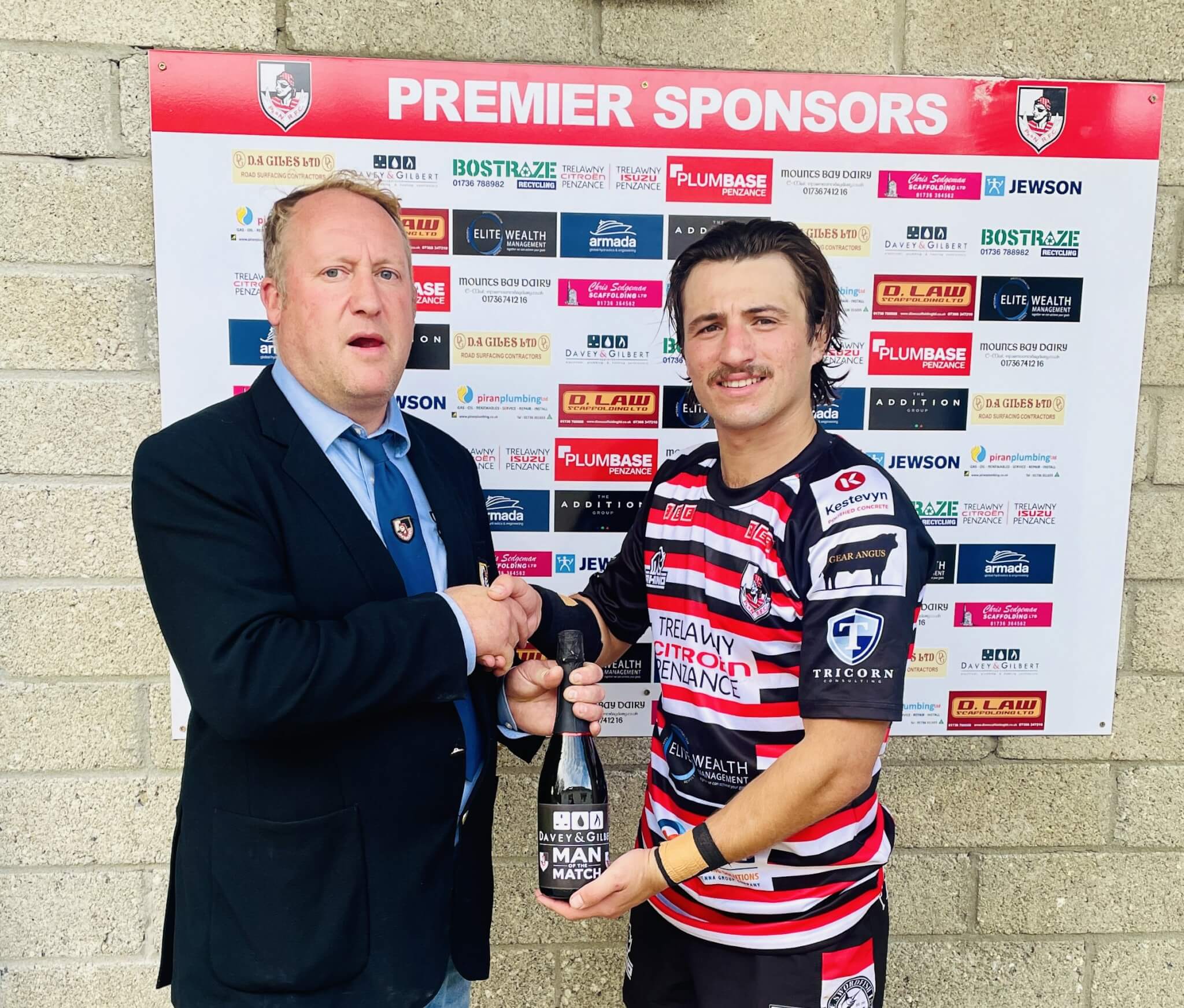 Dan Rhys Evans receiving his man of the match award from Jack Nicholas at the Mennaye Field