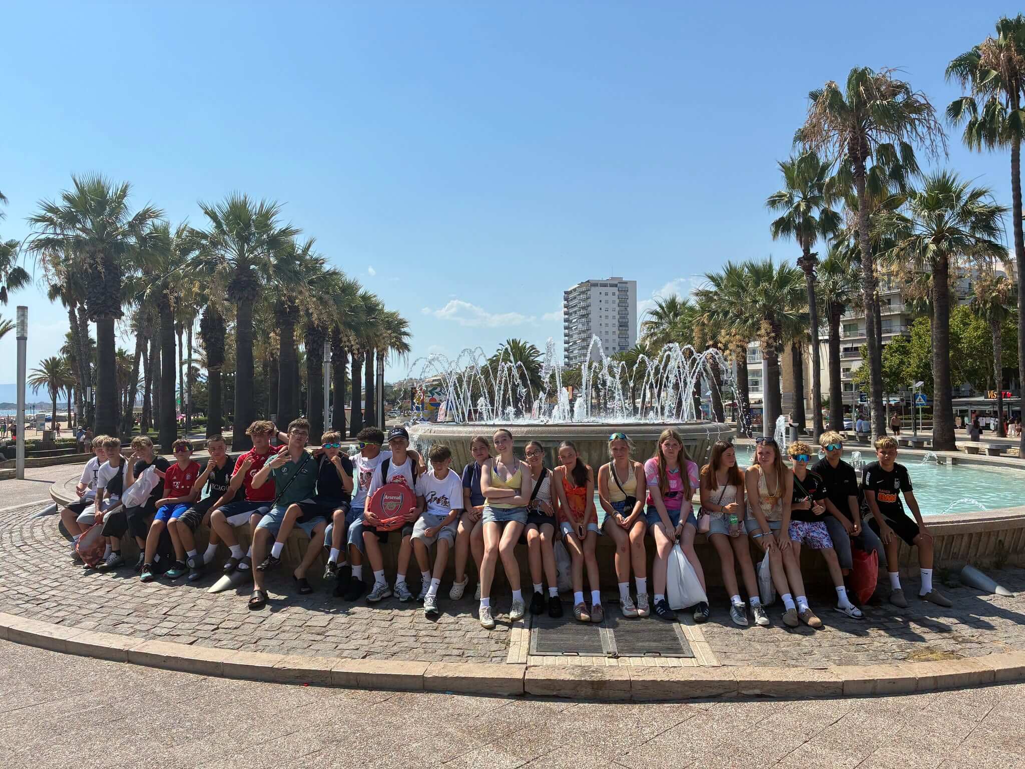 Pool Academy students enjoying the Spanish sun by a fountain