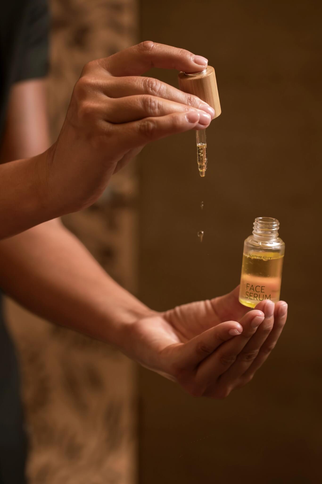 GAIA face serum being dropped into a therapist's hand