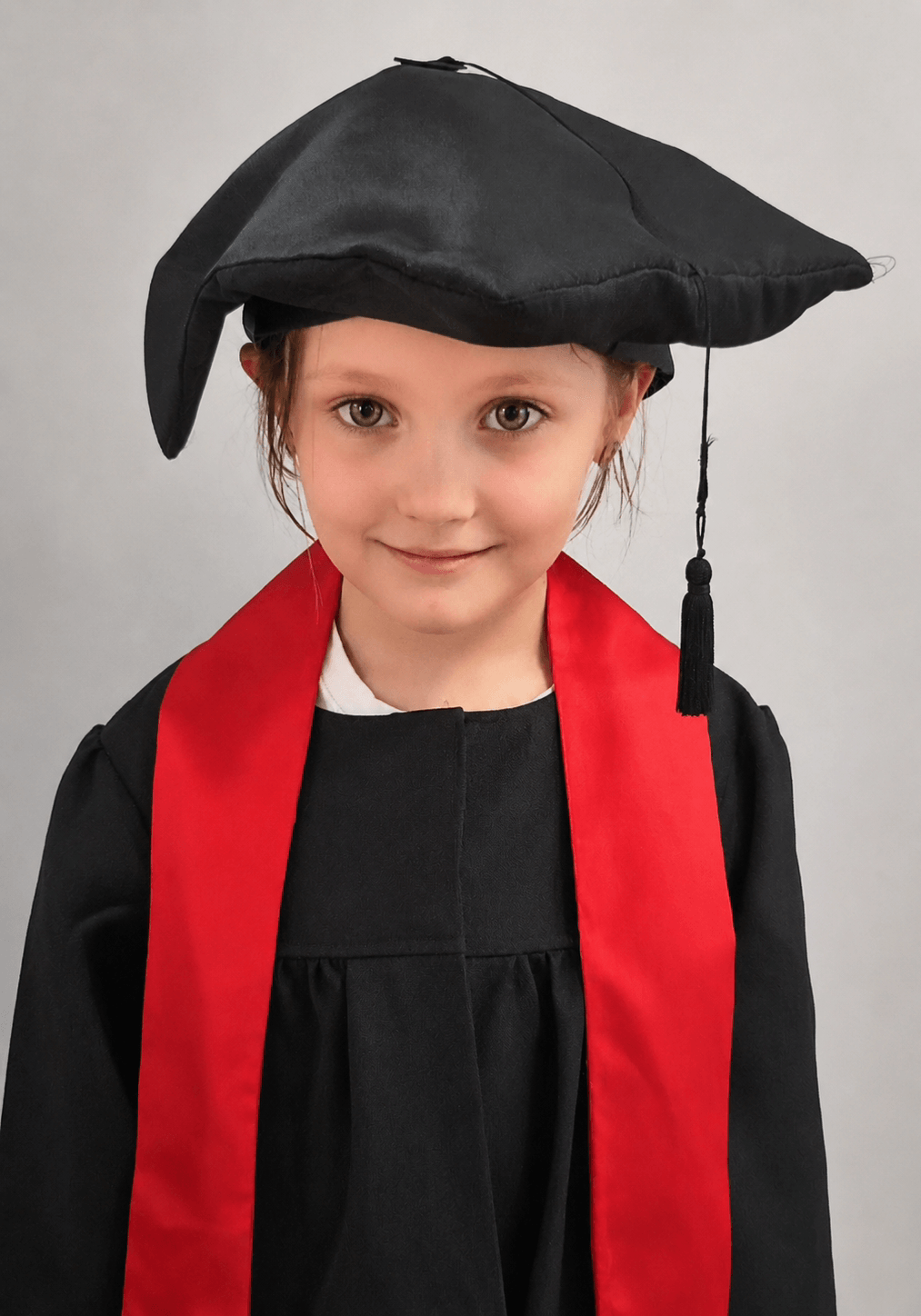 Grace in a graduation cap and gown for her Reception 'graduation'