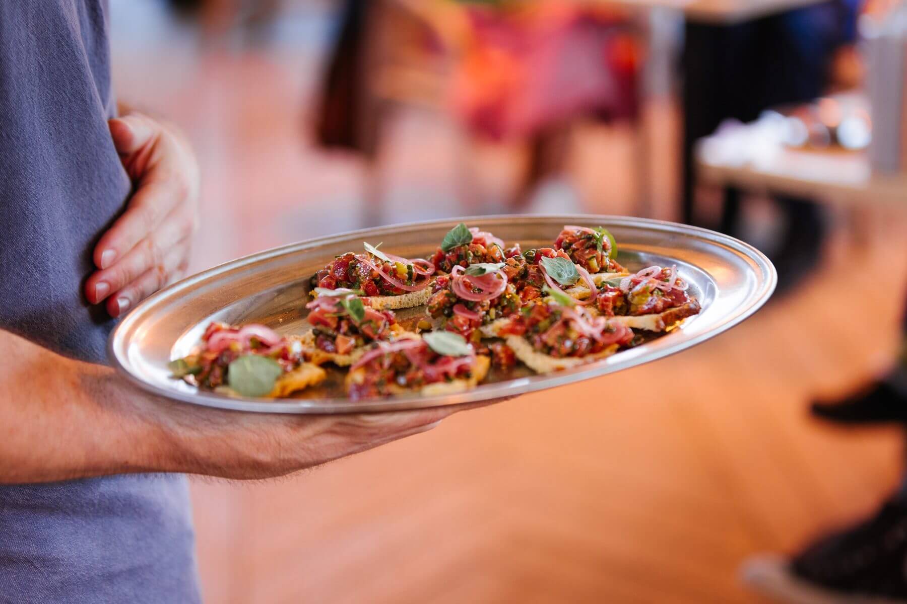 A tray of tuna tartare canapes being served at Gylly Beach