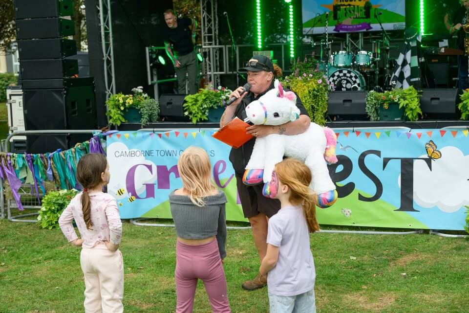 Children with a giant unicorn in front of the Green Fest stage
