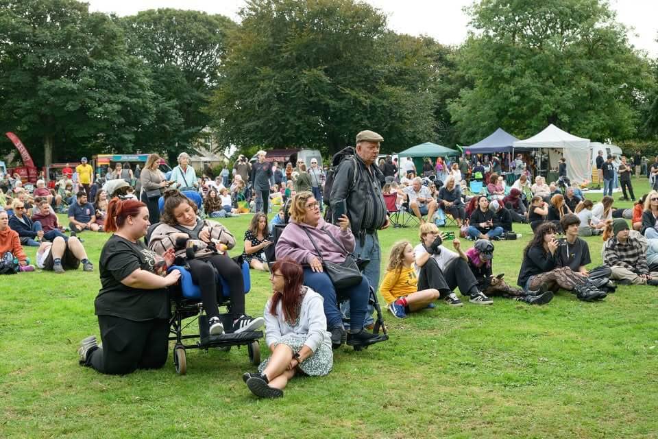 Crowd relaxing on the grass at Camborne Green Fest