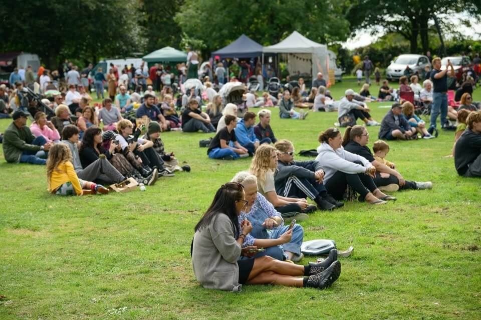 Visitors sitting in the park at Camborne Green Fest