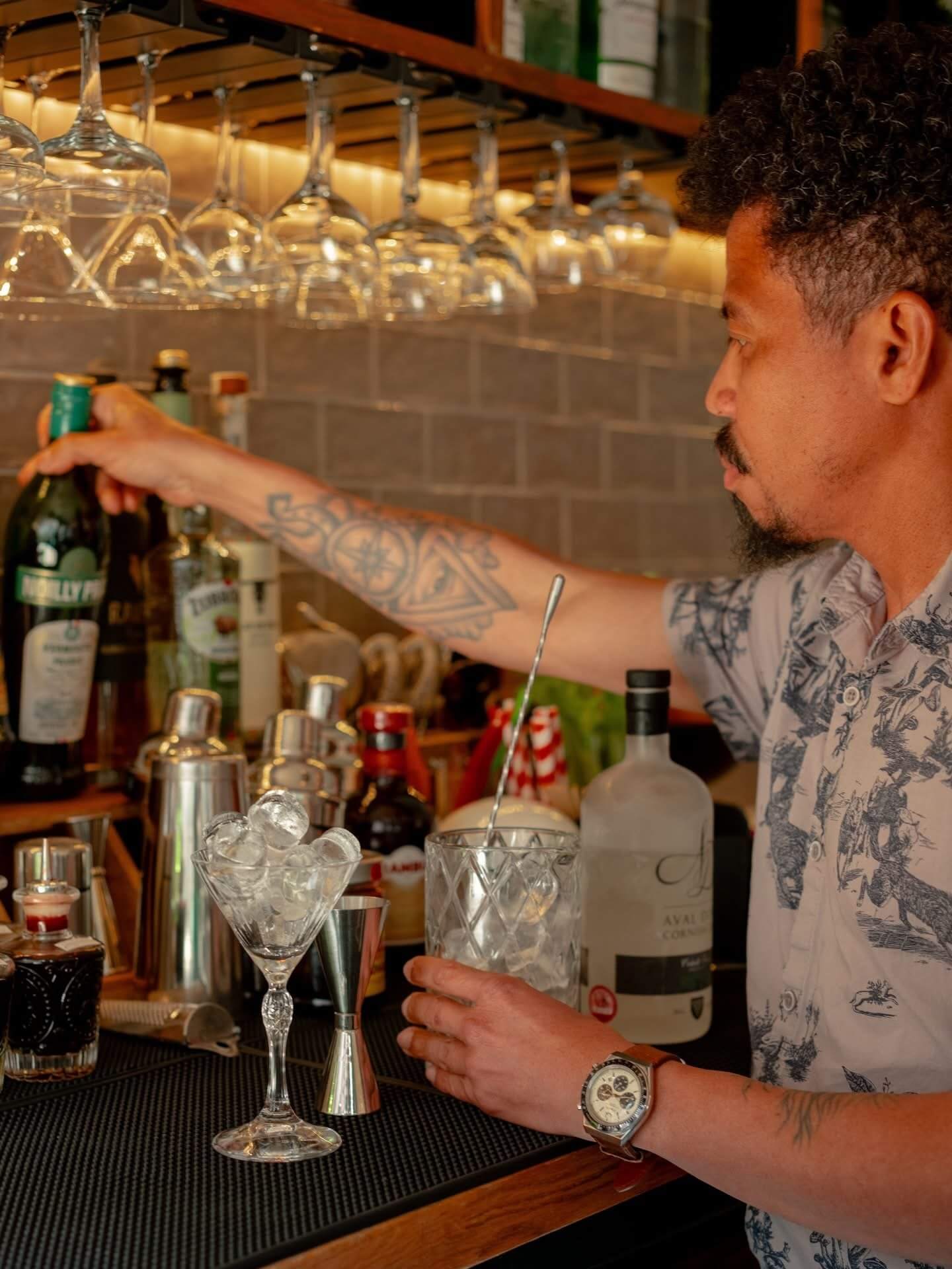 Bartender mixing a cocktail at a Falmouth bar