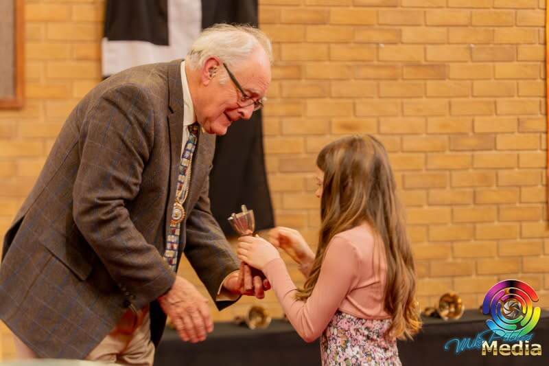 A young performer receiving an award at the Saltash Music, Speech and Drama Festival