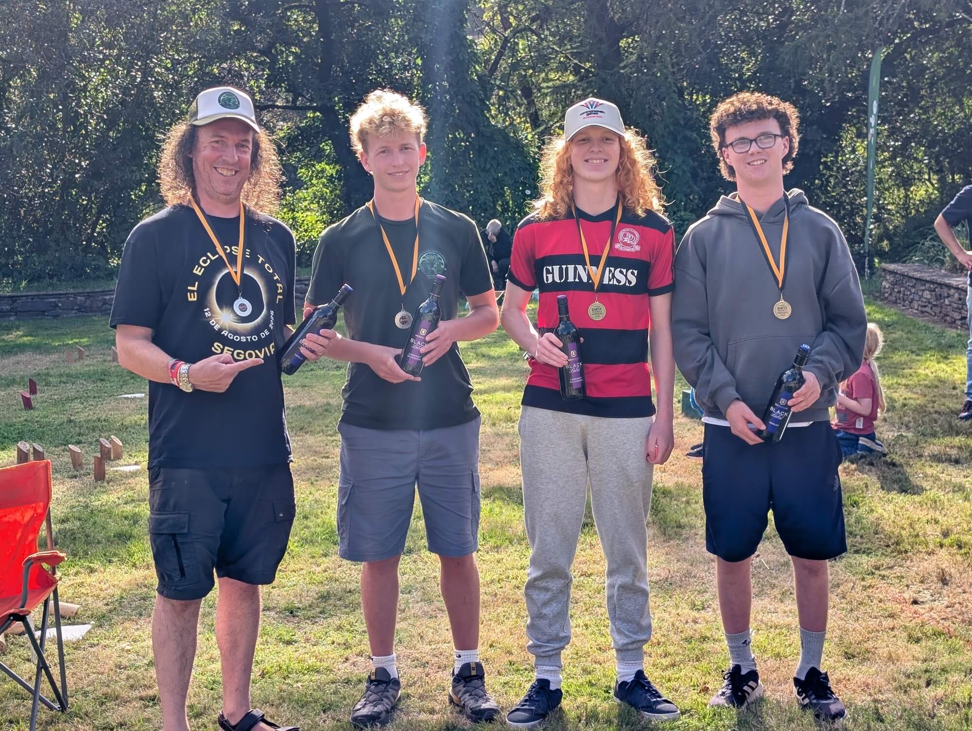 Doubles champions and runners-up holding wine bottles and medals at the World Smite Championships