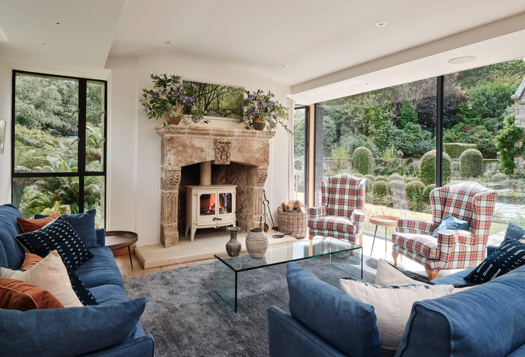 Living room at Hamatethy with a woodburner and tartan armchairs