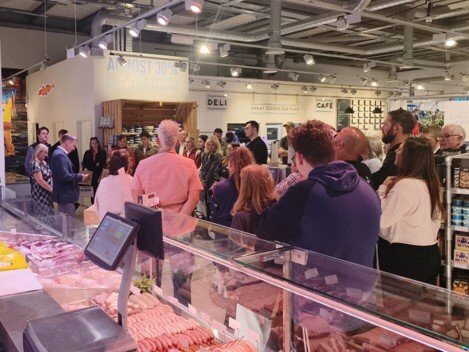 Crowd watching a demonstration at the butchery counter