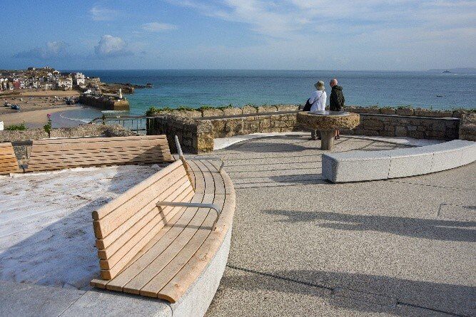Curved timber and granite benches looking out over St Ives Bay