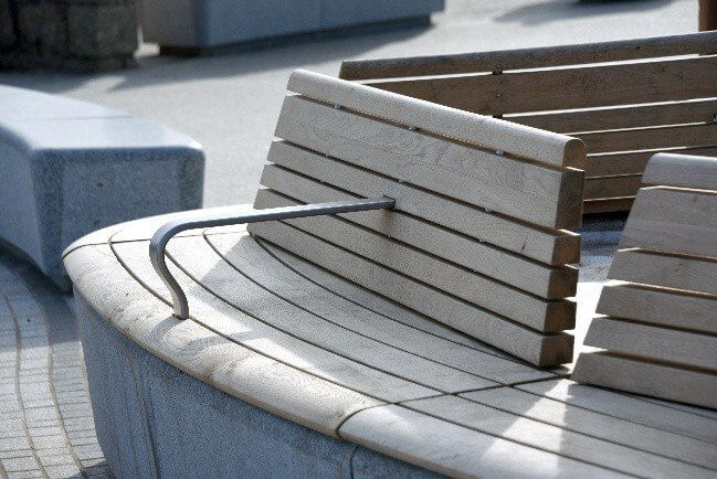 Close-up of the locally sourced timber seating on a granite bench