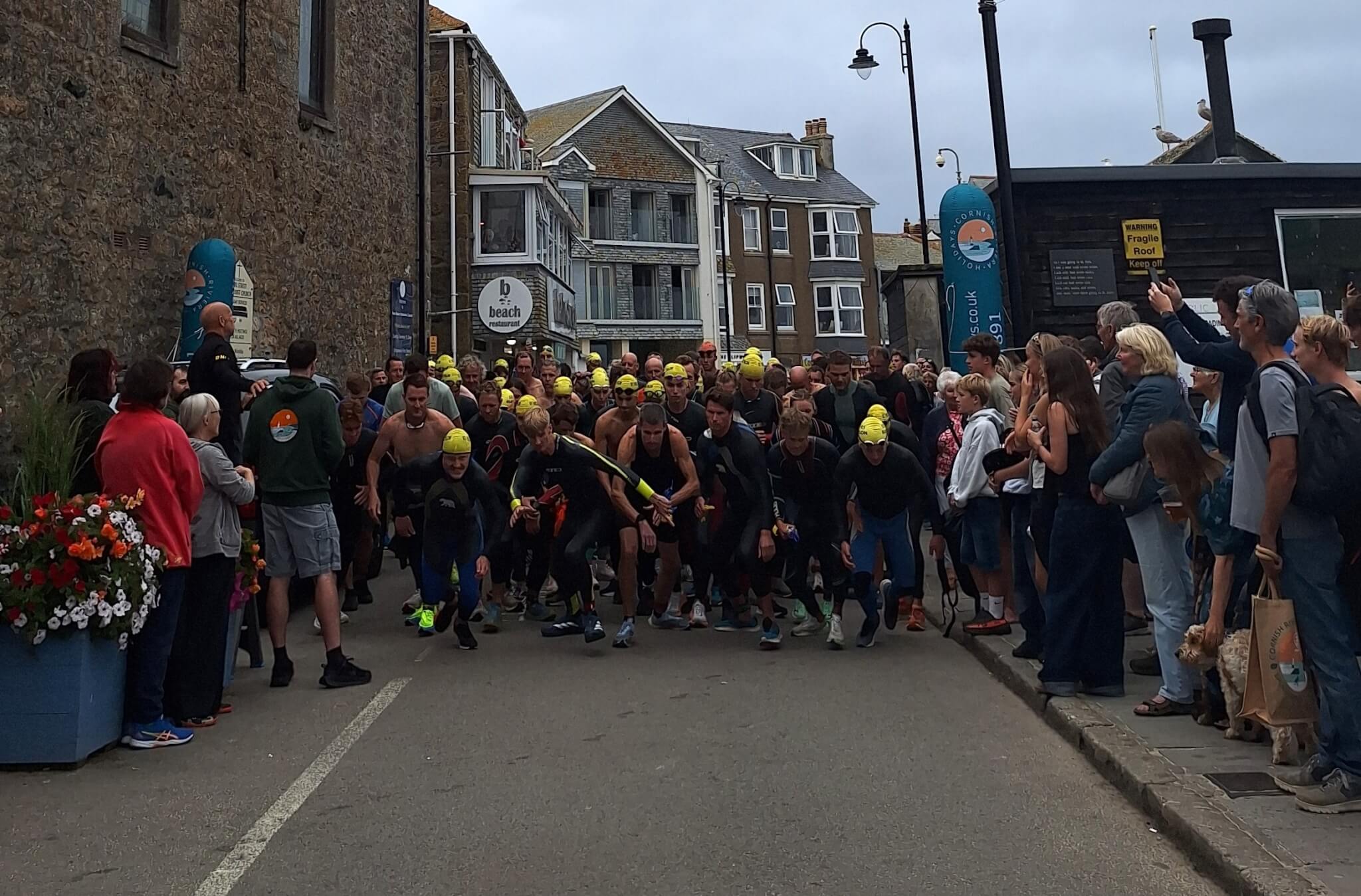 Runners and swimmers set off from the harbour slipway at the start of the St Ives Biathlon