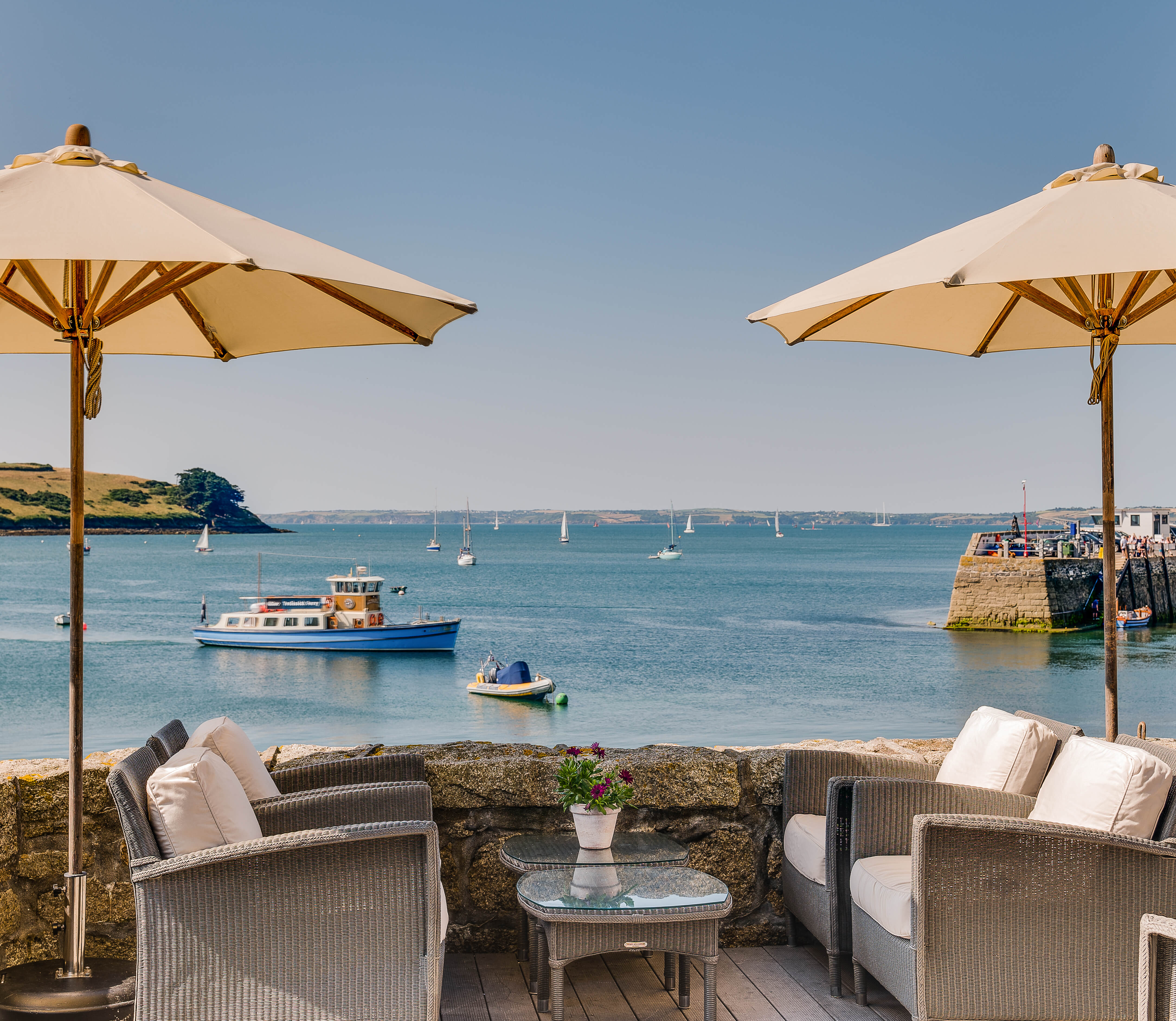 Seating on The Idle Rocks terrace looking out over the water
