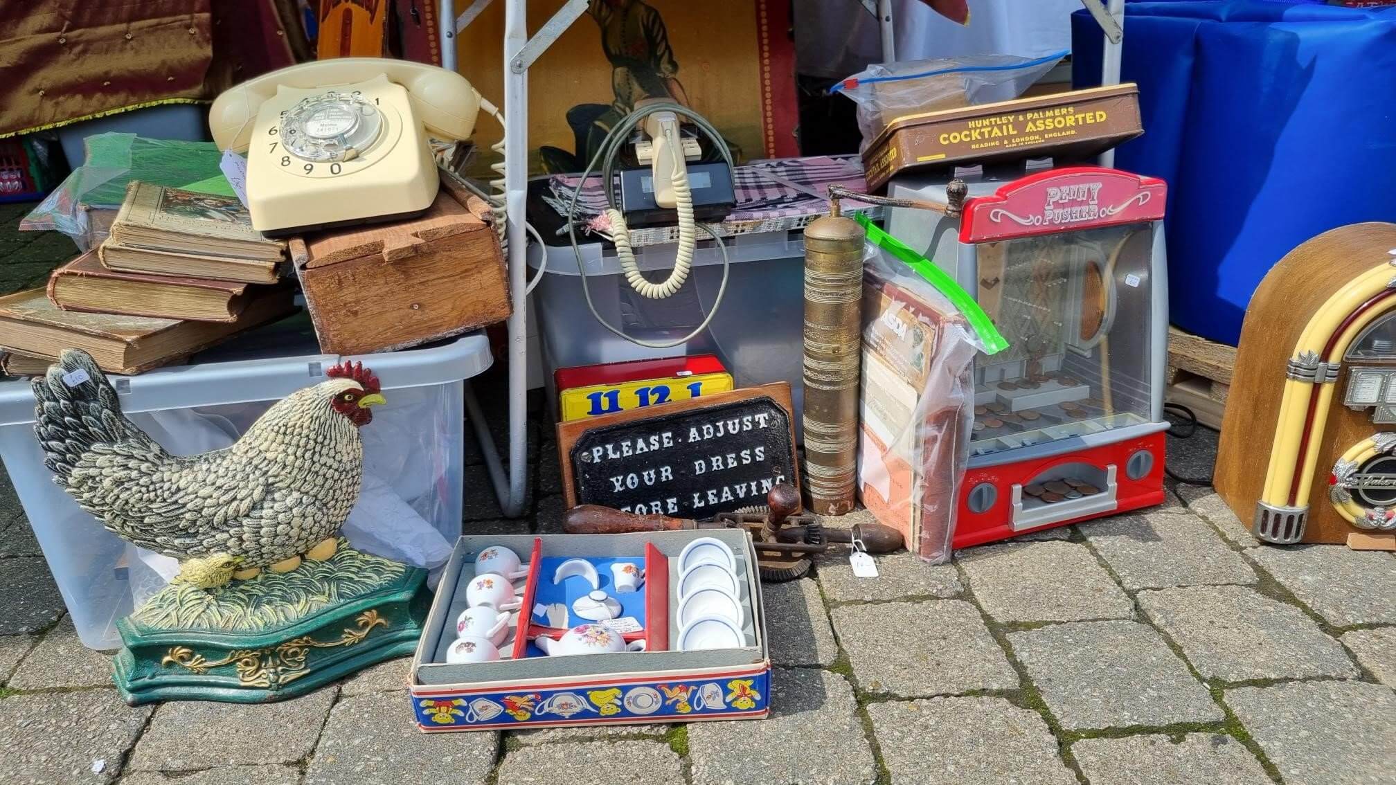 Rotary telephone, old books, a cast-iron hen and vintage tins at a previous Truro antiques market