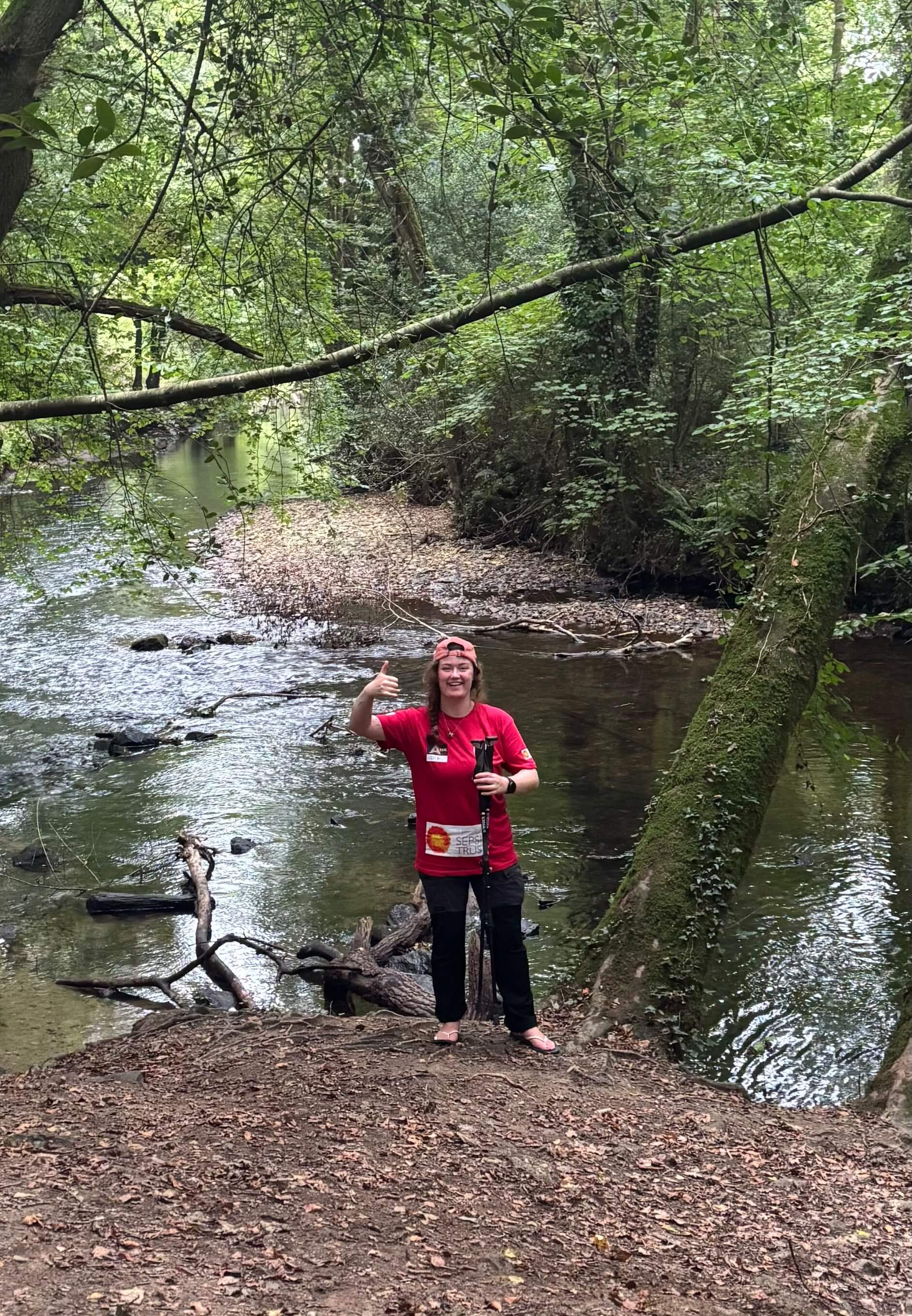 Skye Owen giving a thumbs up beside a Cornish river during training