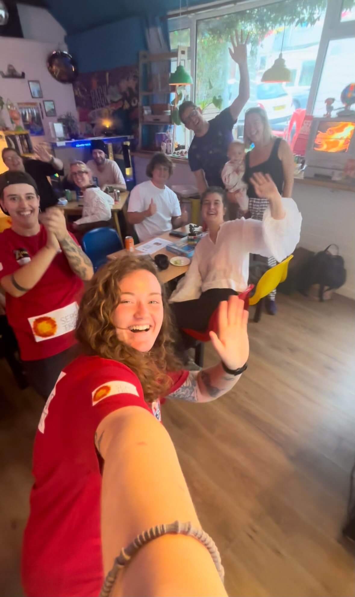 Skye Owen celebrating with supporters indoors after finishing the walk