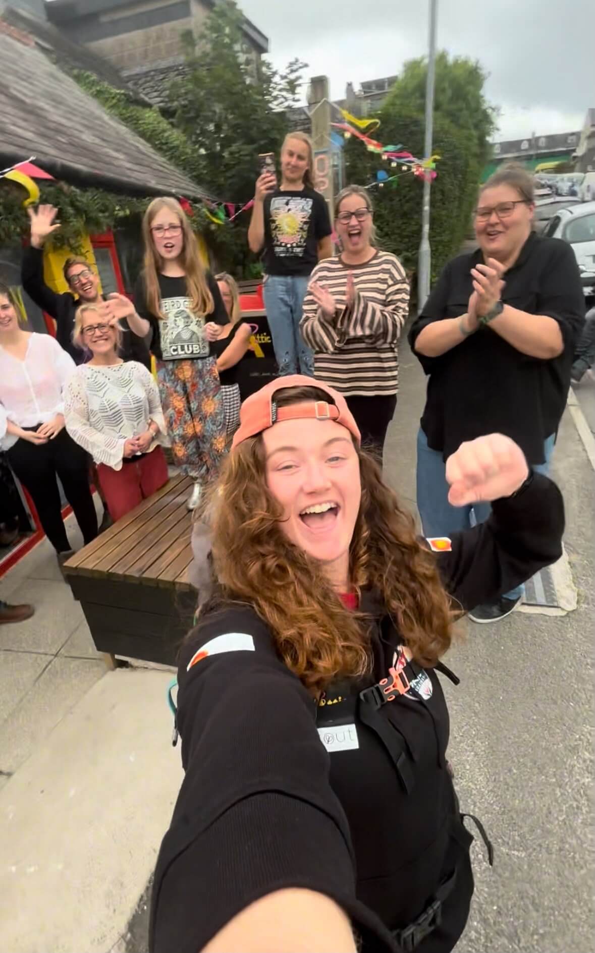 Supporters cheering Skye Owen as she finishes her 24-hour walk