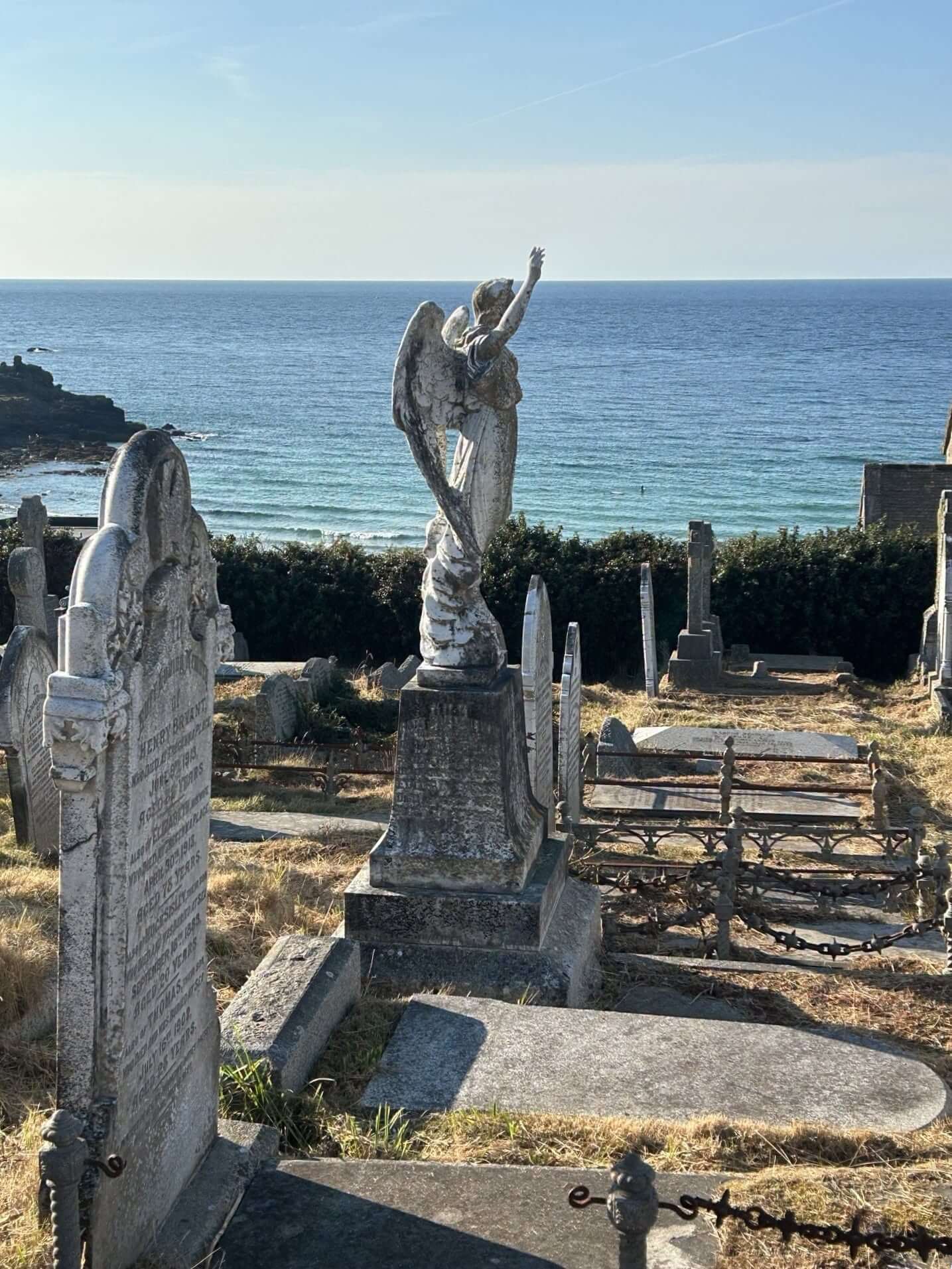 A weathered angel memorial statue at Barnoon Cemetery, St Ives