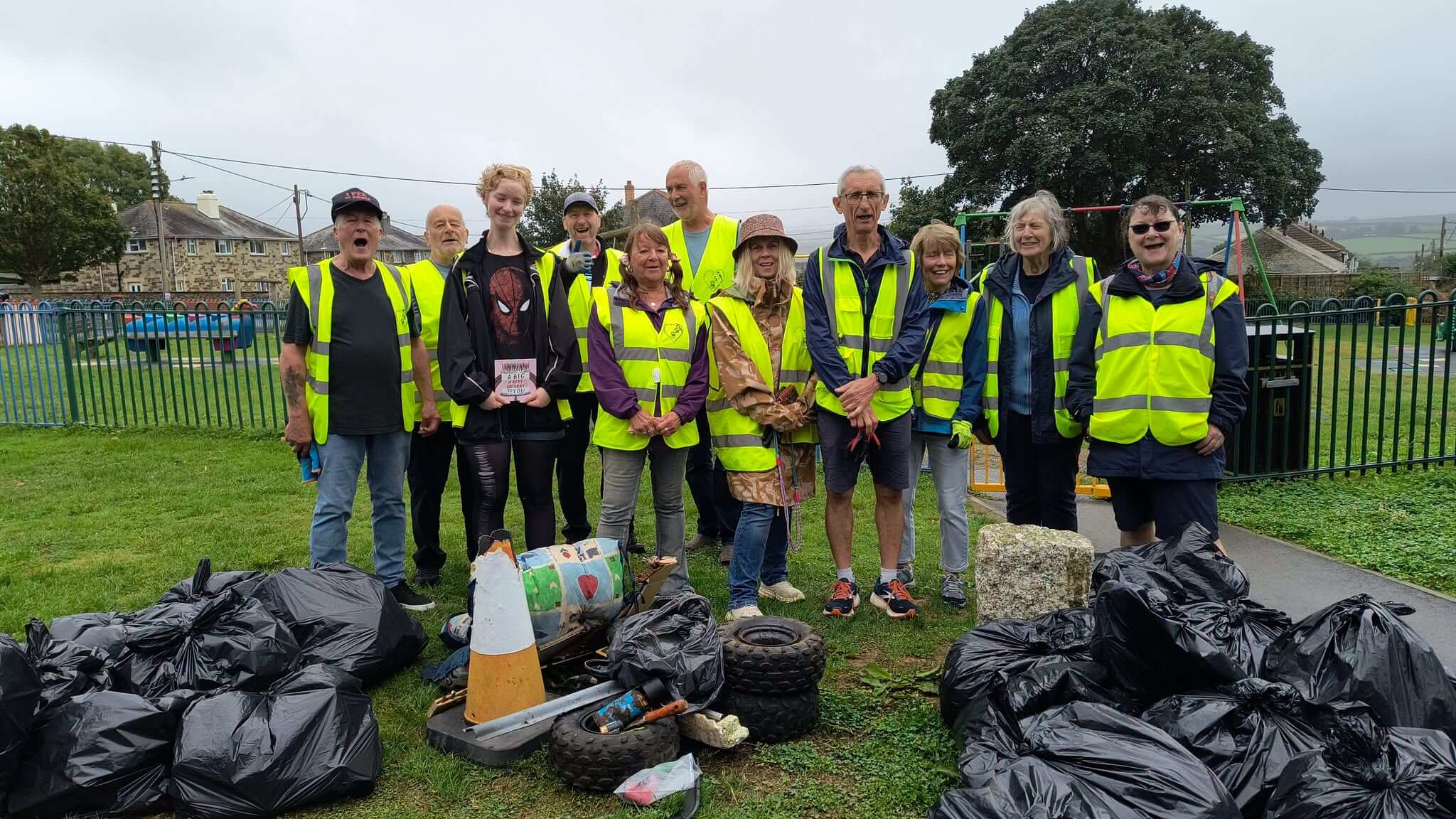 Bodmin Tidy it Team volunteers with bags of collected litter at Fair Park