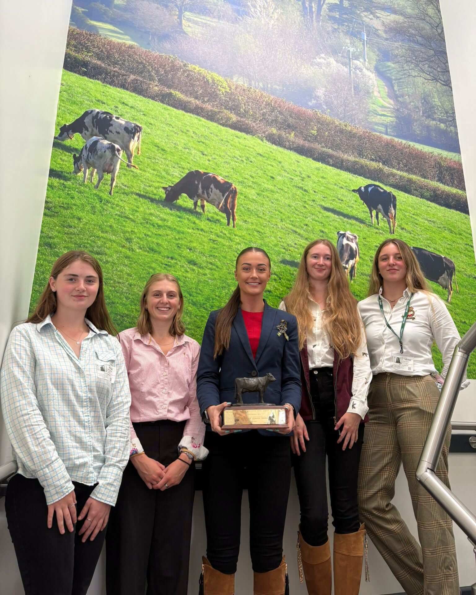 Holly with fellow Duchy College students in front of a farming mural
