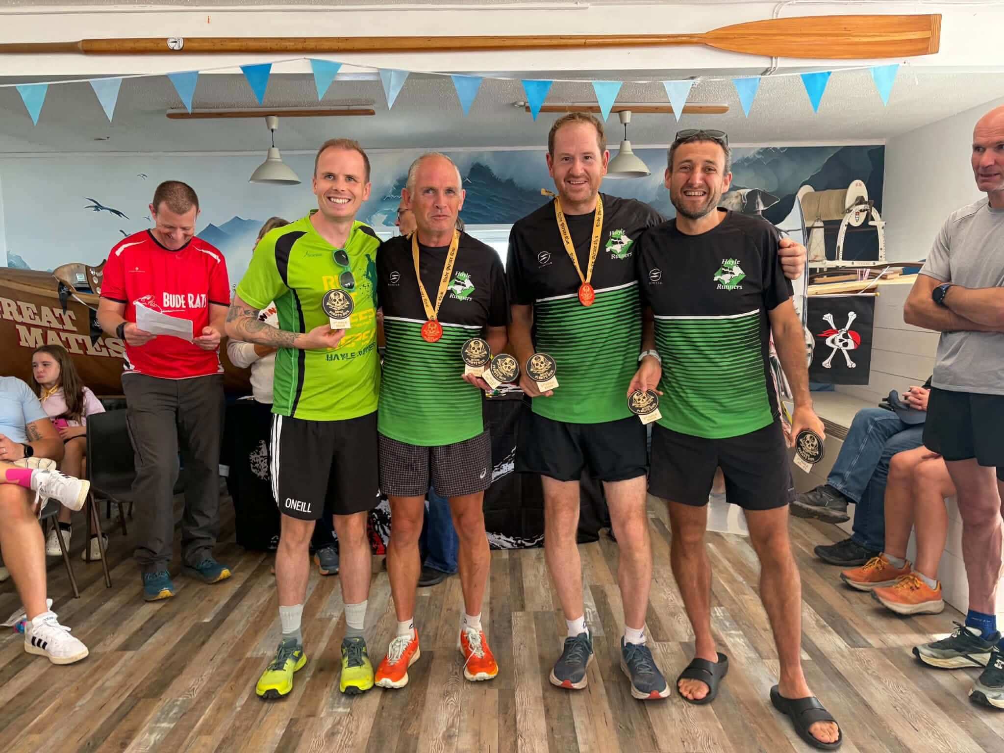 Hayle Runners men's team with their Bude Pirate Run medals and trophies