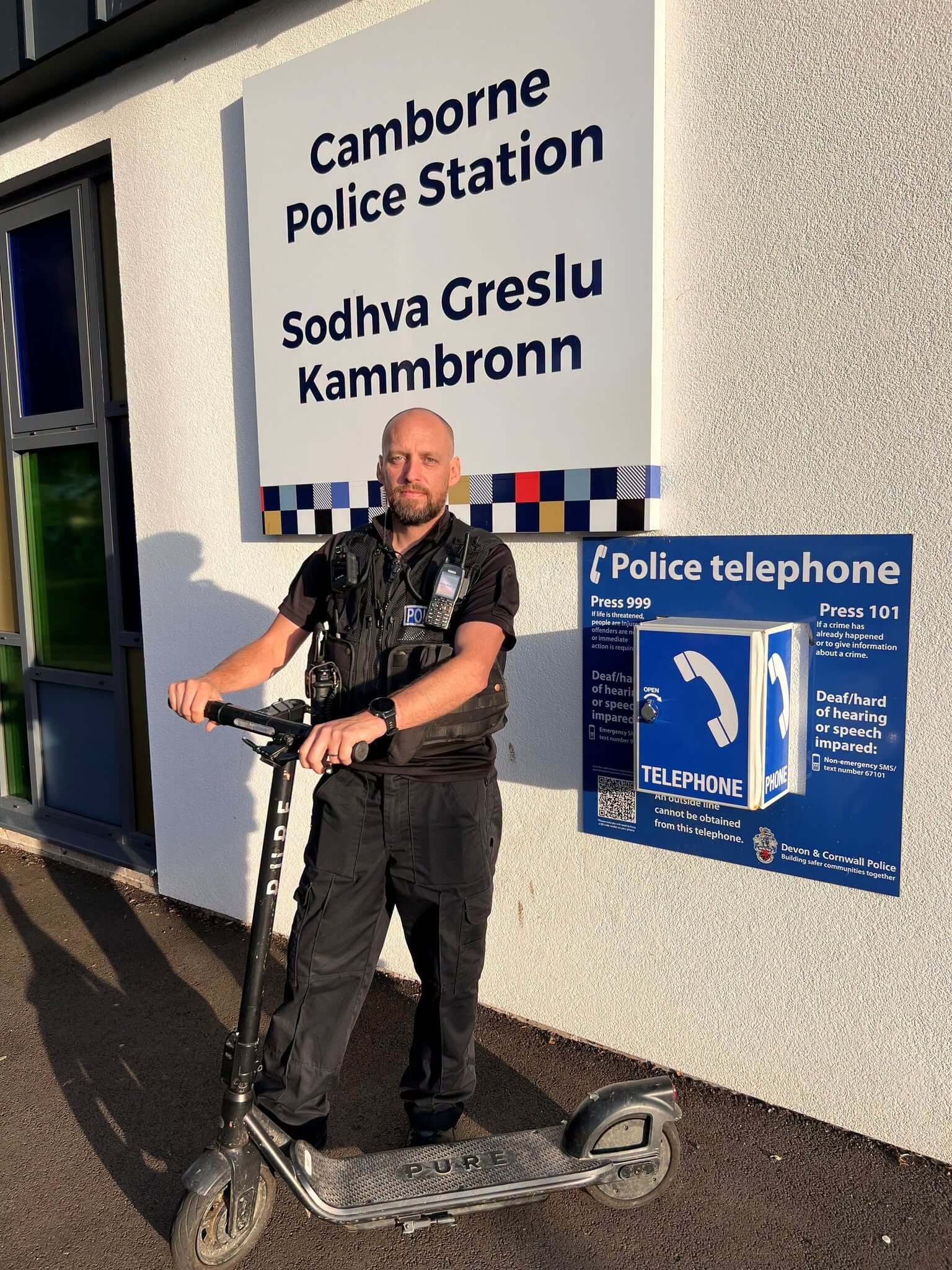 Police officer with a seized electric scooter outside Camborne Police Station