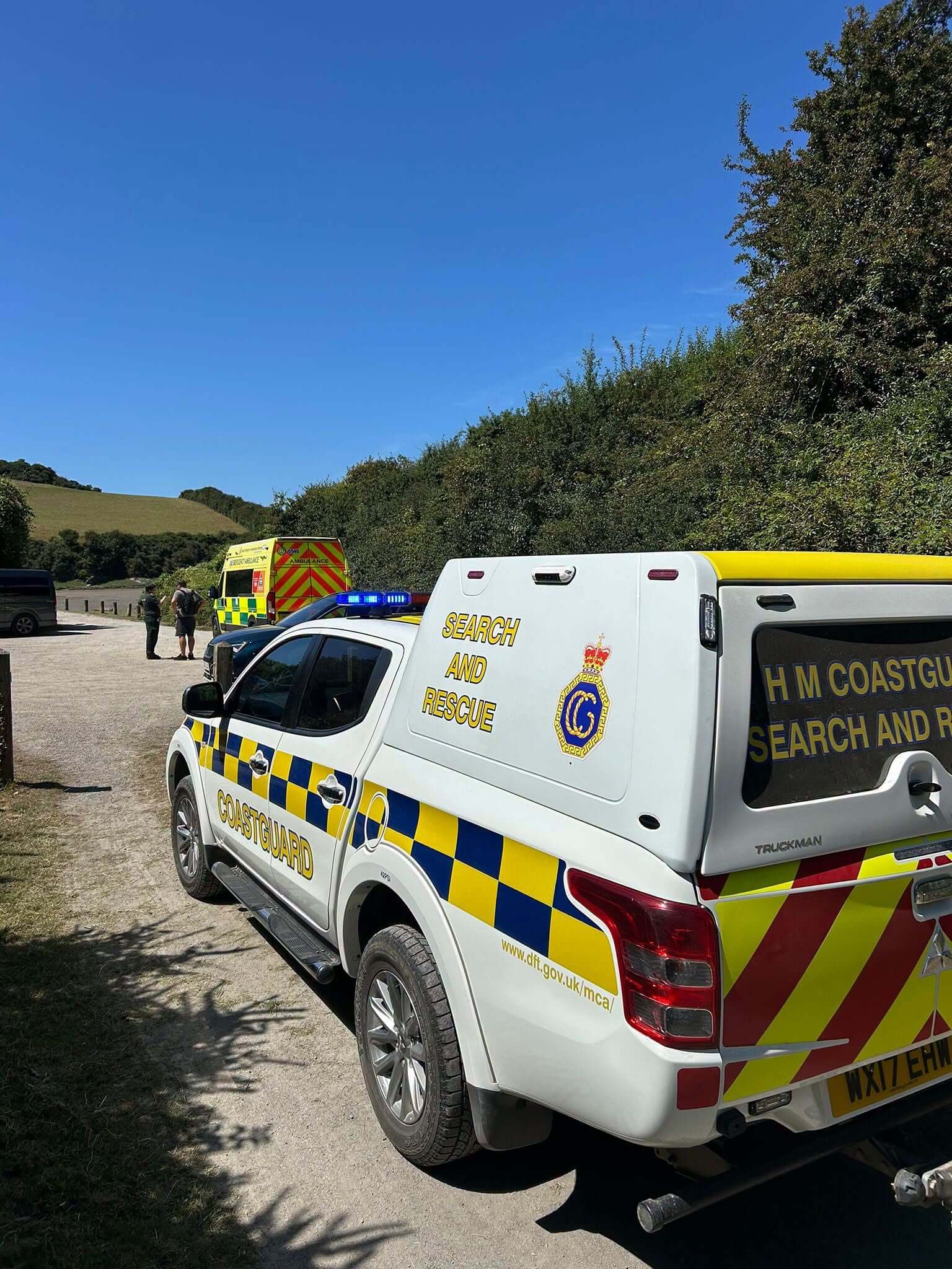 HM Coastguard Padstow search and rescue vehicle at the Camel Trail with an ambulance in the background