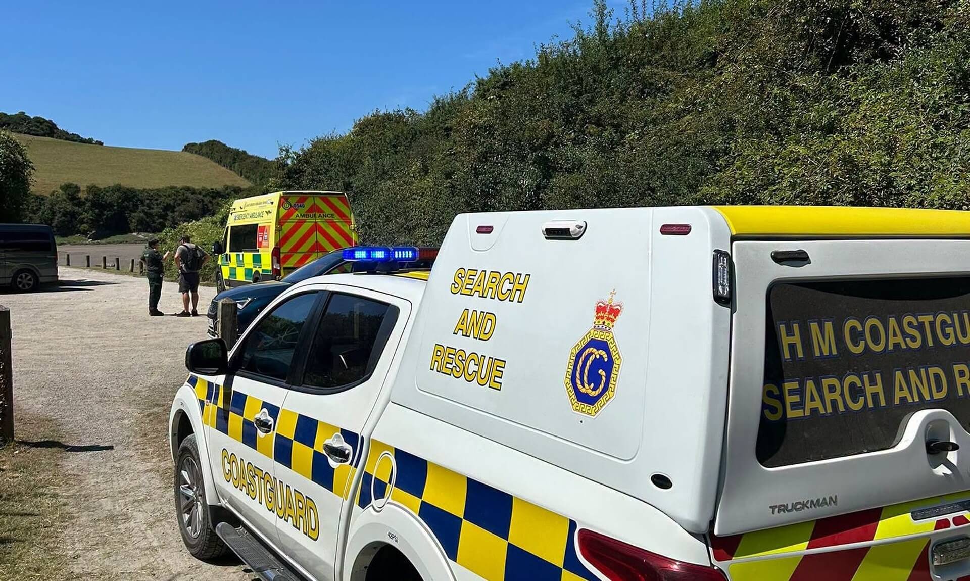 HM Coastguard Padstow search and rescue vehicle at the Camel Trail with an ambulance in the background