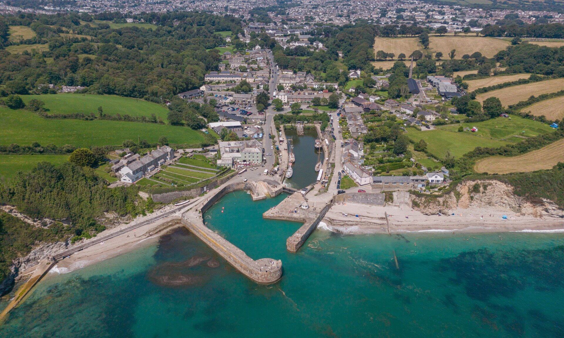 Aerial view of Charlestown Harbour with its inner basin, piers and turquoise sea