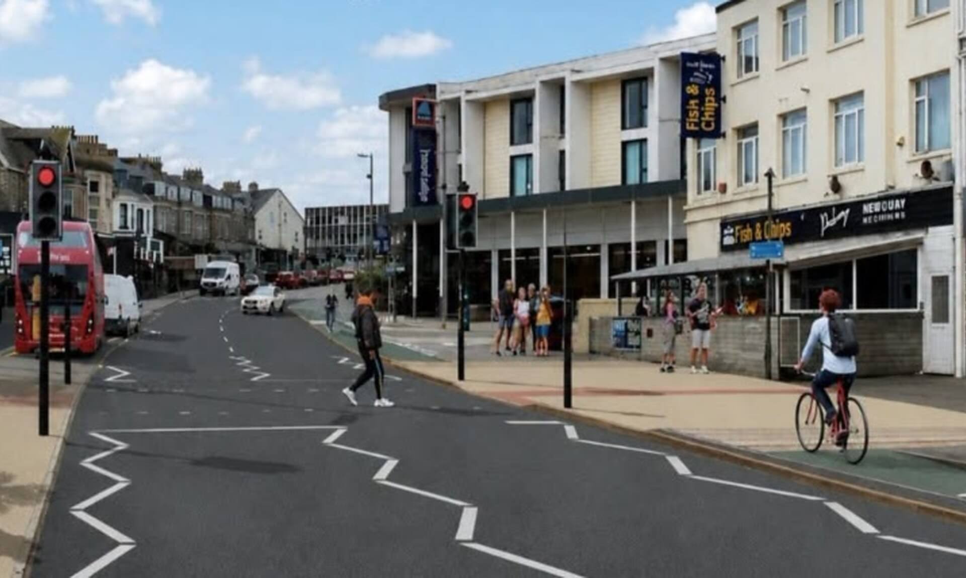 Cliff Road in Newquay with shops, a traffic light and pedestrians
