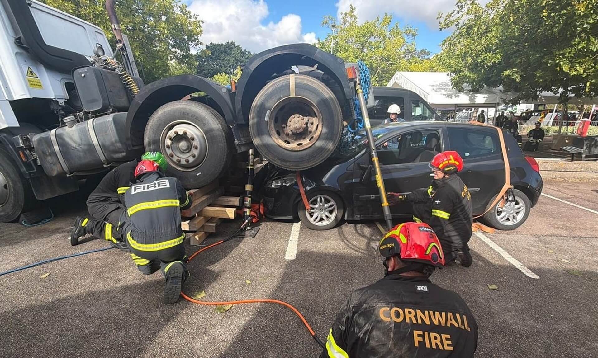 Cornwall firefighters help lift a lorry off a car during the Heavy Rescue Challenge