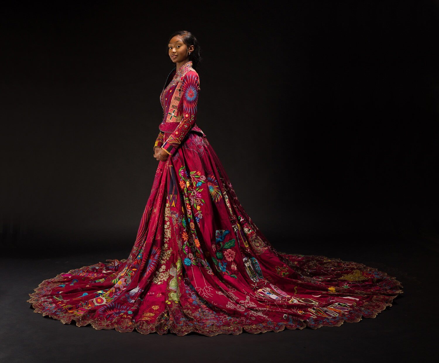 Lekazia Turner wearing The Red Dress with its long embroidered train