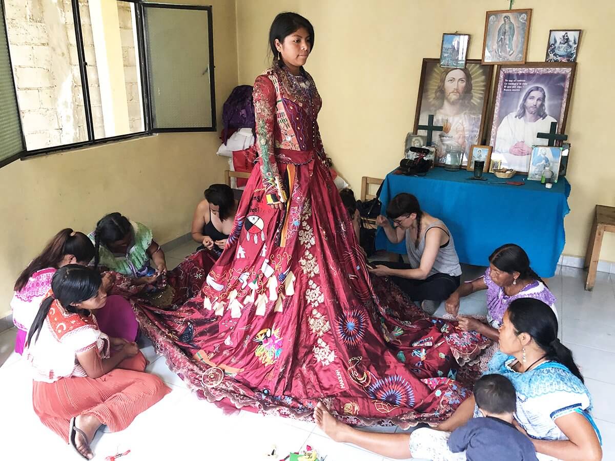 Women embroidering The Red Dress in Aguacatenang, Mexico