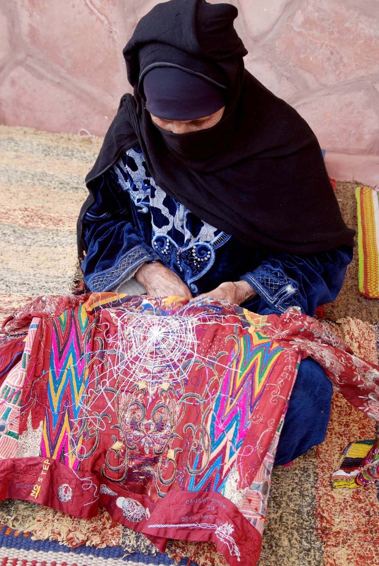 Hamida Gabaly hand-stitching a panel of The Red Dress in Egypt