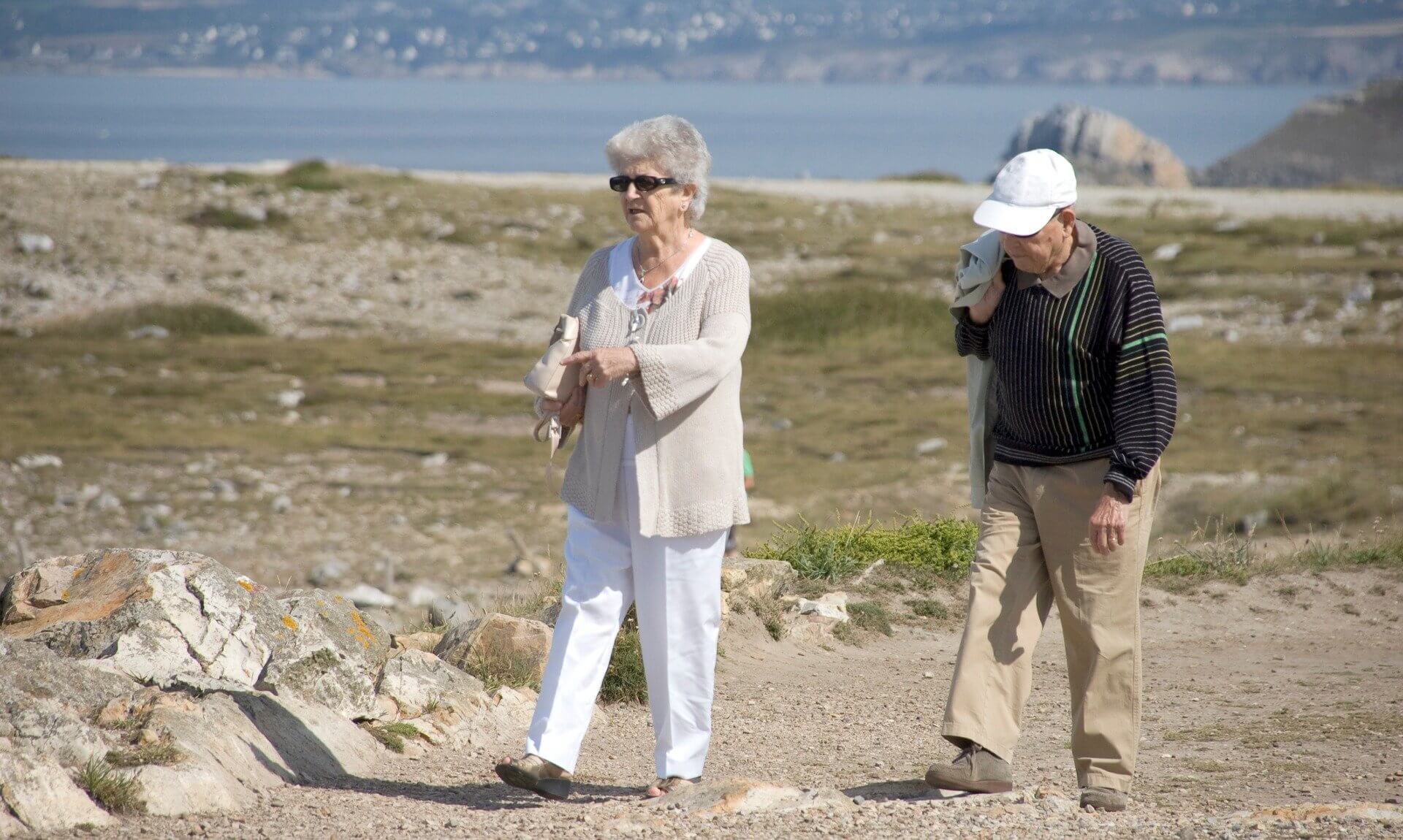Older couple walking on a coastal clifftop path