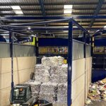 Forklift loader moving baled paper at a Cornwall recycling facility