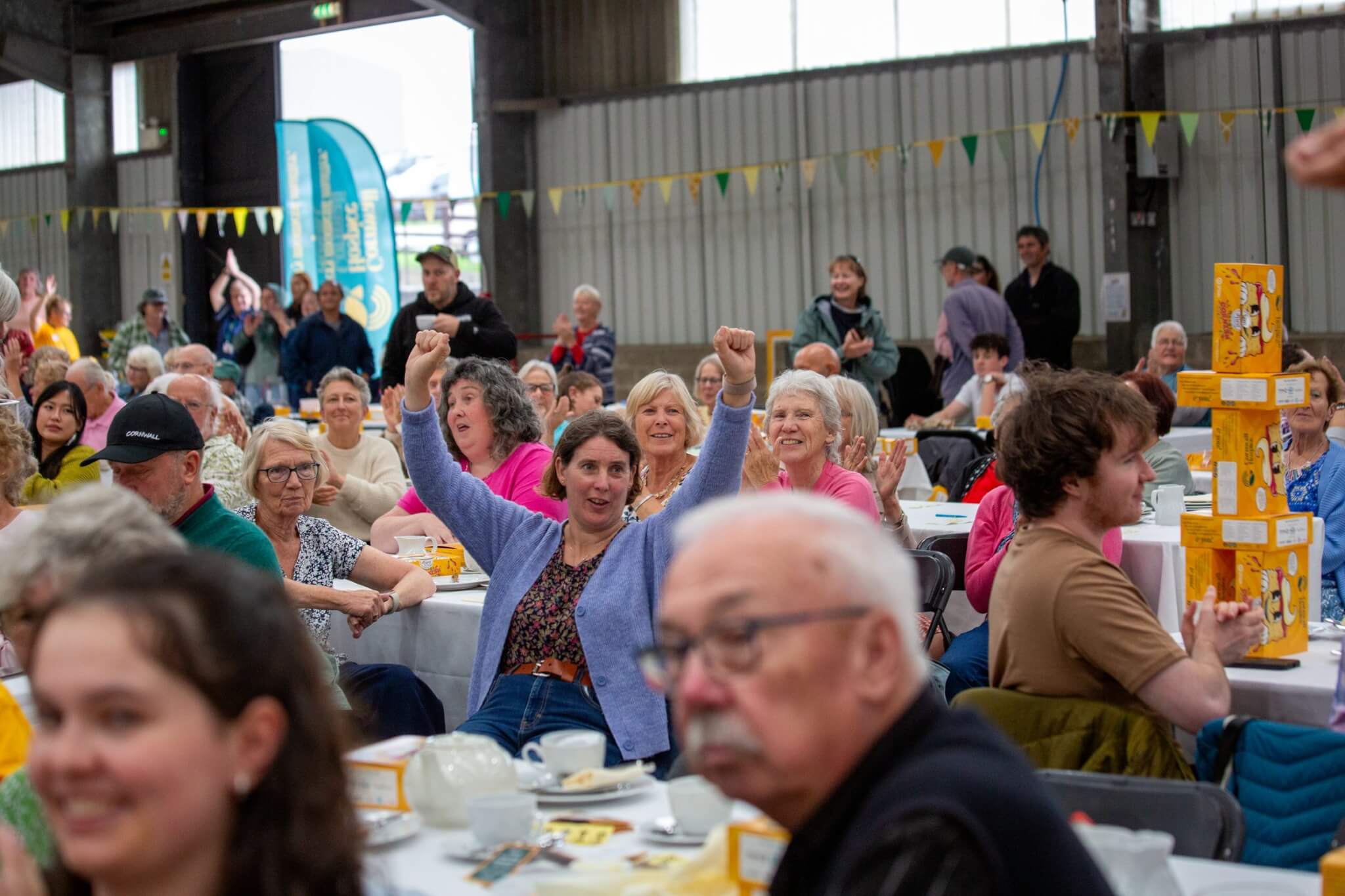 Supporters cheering as Cornwall Hospice's cream tea party record is confirmed