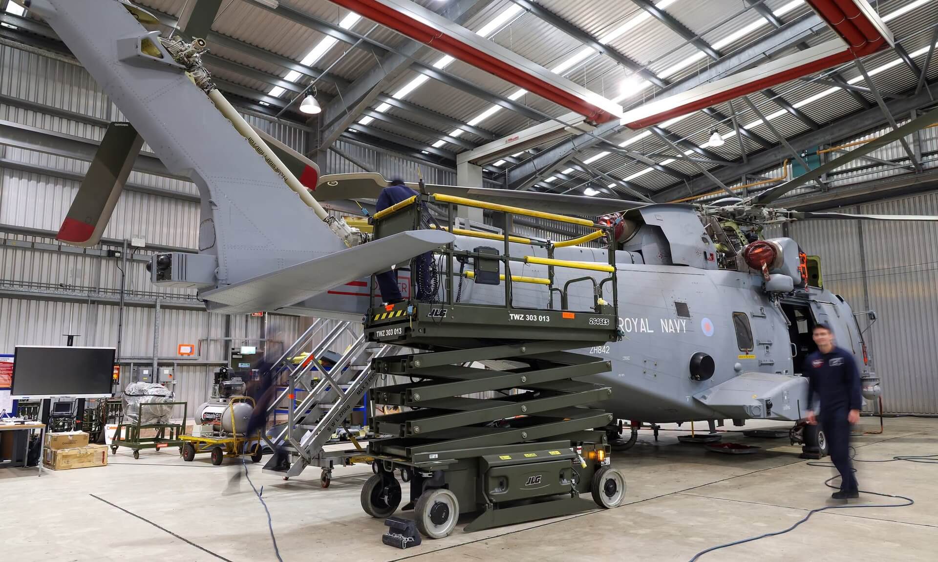 Royal Navy Merlin helicopter undergoing maintenance in a Culdrose hangar