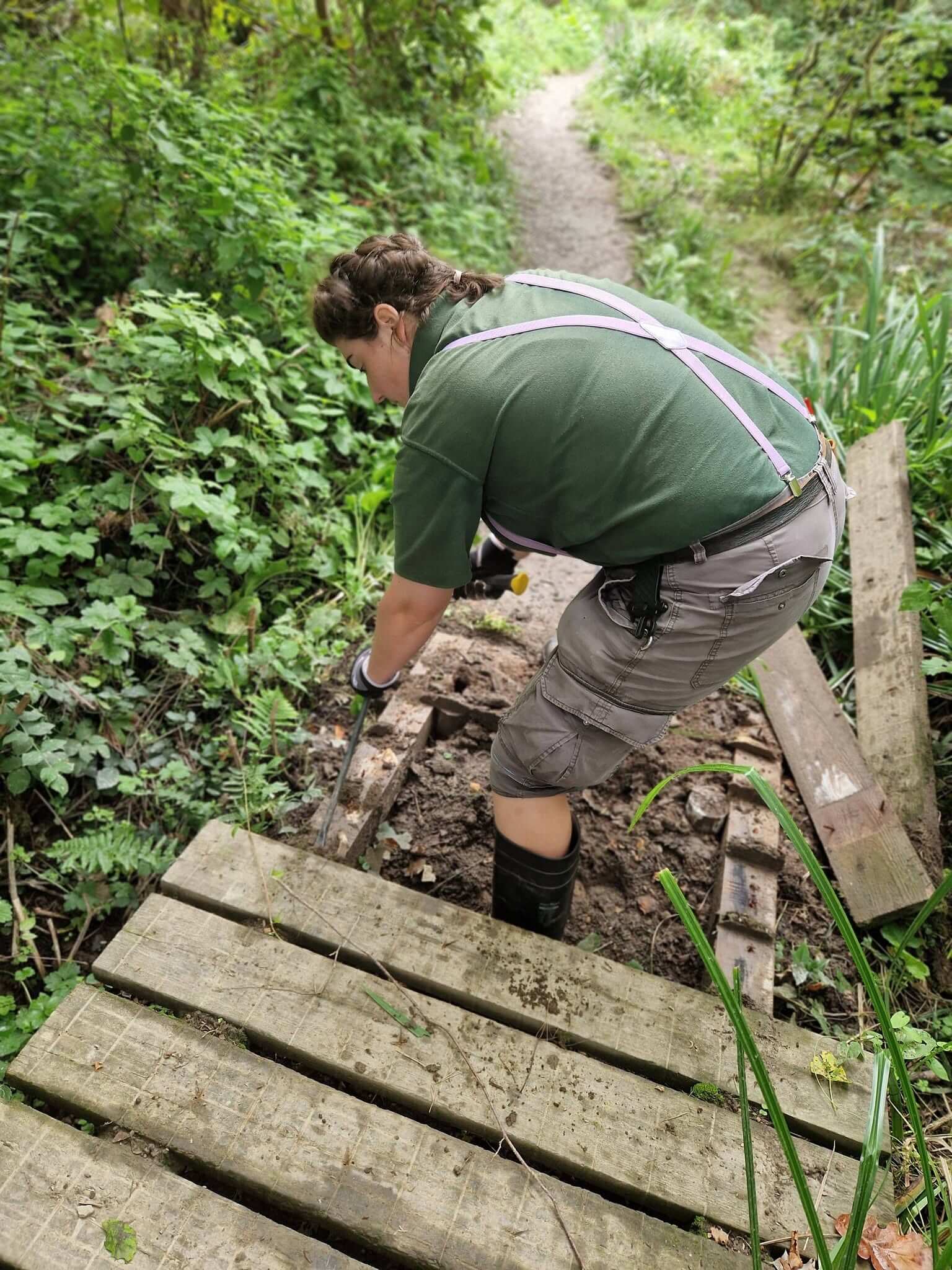 A ranger lifting the old boardwalk at Daubuz Moor