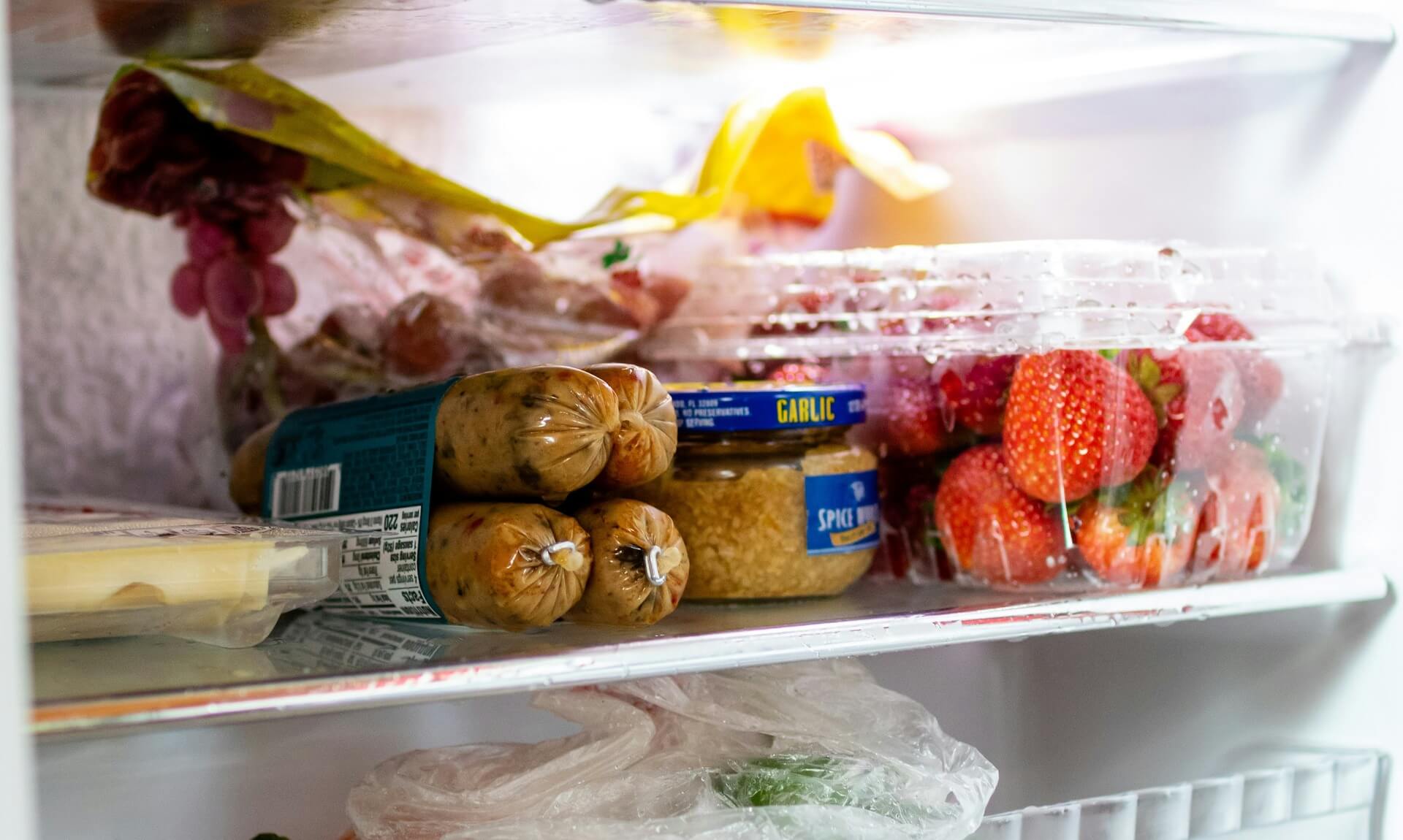 An open fridge in a Cornwall kitchen packed with fresh food